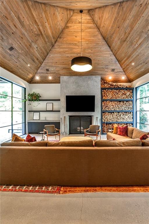 unfurnished living room featuring a wealth of natural light, a large fireplace, wood ceiling, and lofted ceiling