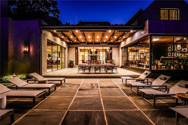 back house at night with a patio area