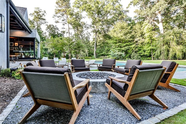 view of patio featuring an outdoor living space with a fire pit