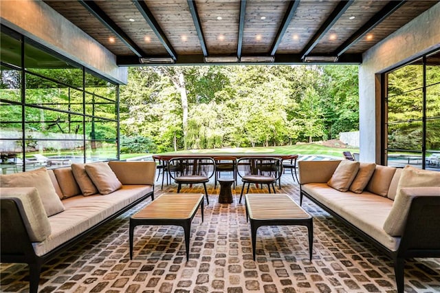 sunroom with beam ceiling, wooden ceiling, and a healthy amount of sunlight