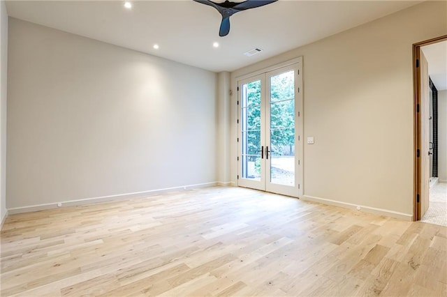 empty room featuring ceiling fan, french doors, and light hardwood / wood-style floors