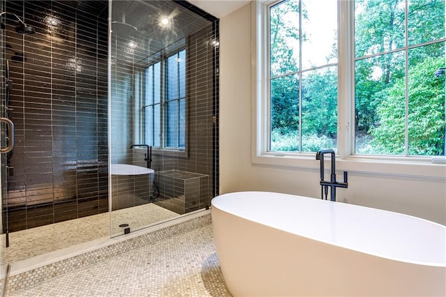 bathroom featuring plenty of natural light, tile patterned flooring, and shower with separate bathtub