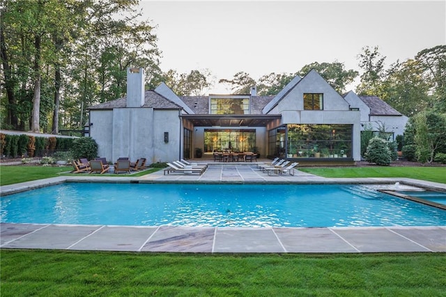 view of pool featuring a yard and a patio