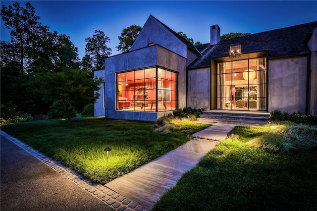 rear view of property featuring a yard