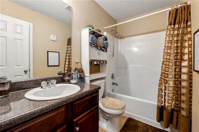 bathroom with a textured ceiling, vanity, shower / bath combo with shower curtain, and toilet