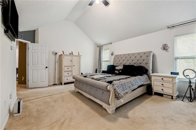 bedroom featuring multiple windows, vaulted ceiling, and carpet flooring