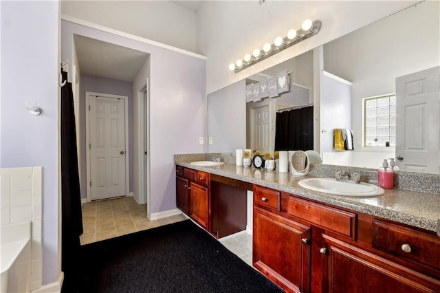 full bathroom featuring double vanity, baseboards, a sink, and a bath