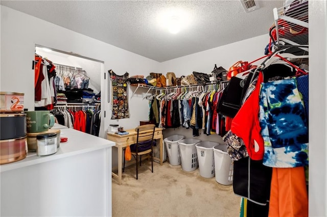 walk in closet with carpet floors and visible vents