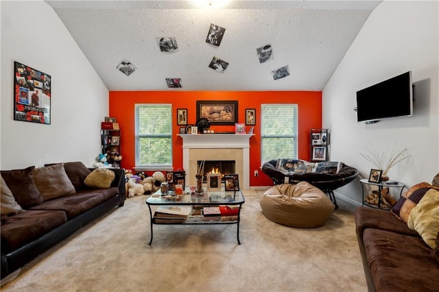 living area featuring carpet flooring, vaulted ceiling, a lit fireplace, and a textured ceiling