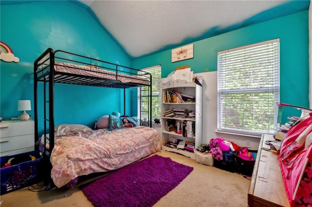 carpeted bedroom featuring lofted ceiling and a textured ceiling