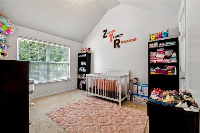 carpeted bedroom with lofted ceiling, a textured ceiling, and baseboards