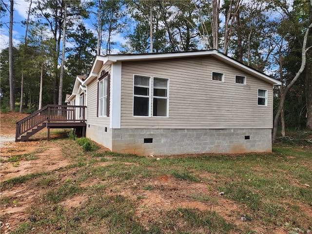 view of home's exterior with a wooden deck