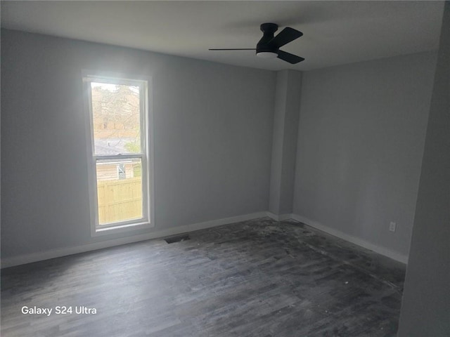 unfurnished room with a ceiling fan, baseboards, and wood finished floors