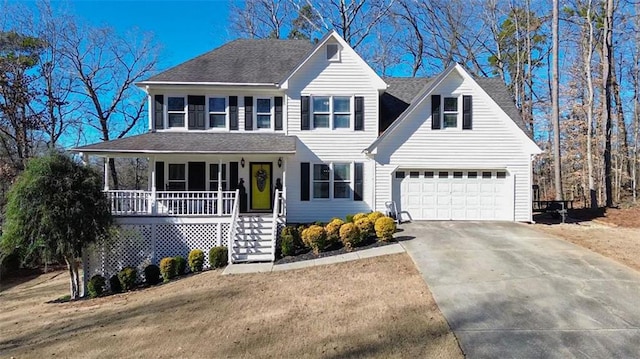 view of front of home featuring a garage, a front lawn, and a porch