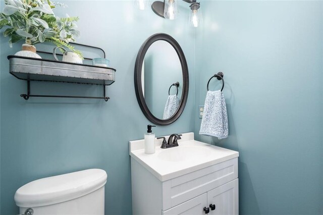 bathroom with toilet and vanity