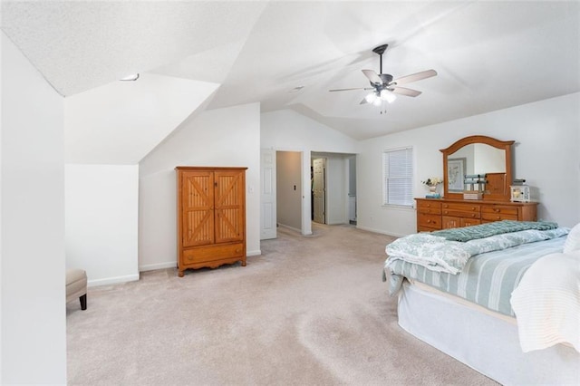 bedroom with ceiling fan, light colored carpet, and vaulted ceiling