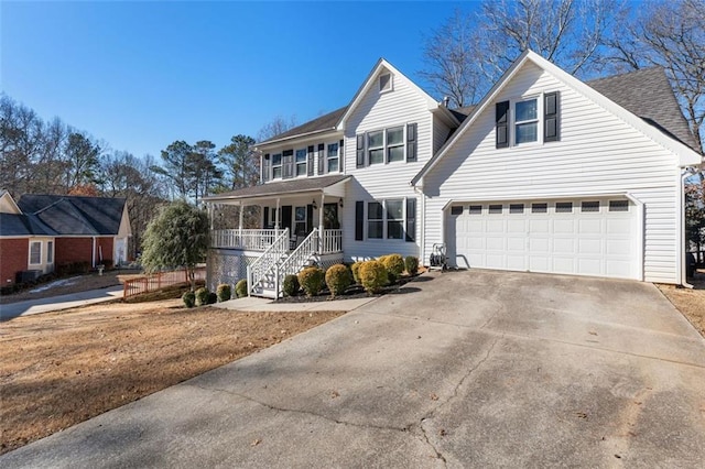 front of property featuring covered porch and a garage