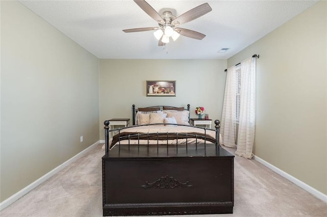 bedroom with ceiling fan and light colored carpet