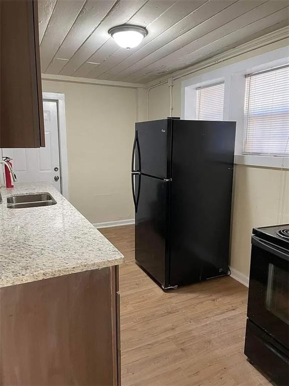 2771 Mann Rd, Winston, GA 30187 - kitchen with black appliances, wooden ceiling, light wood-type flooring, and light stone countertops