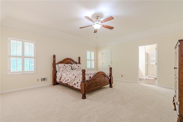 bedroom featuring visible vents, baseboards, multiple windows, and light colored carpet