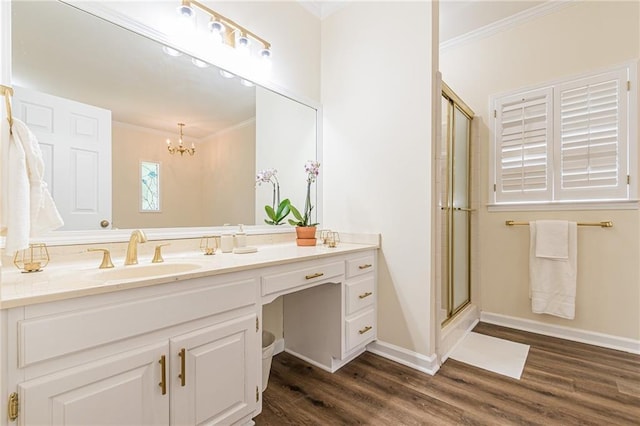 bathroom with ornamental molding, wood finished floors, and a chandelier