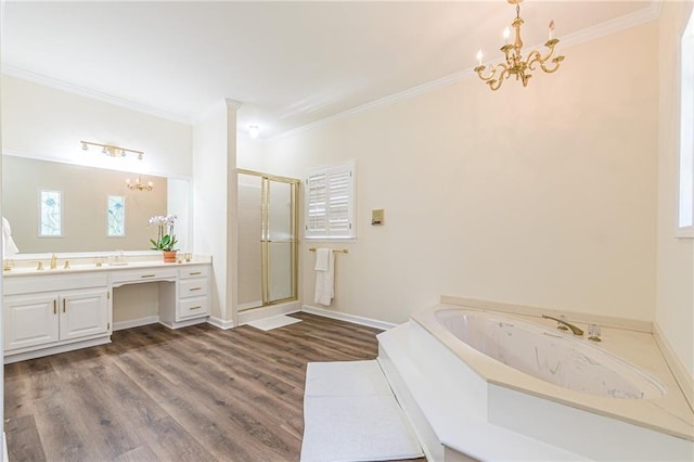 full bathroom with crown molding, a stall shower, wood finished floors, vanity, and a chandelier