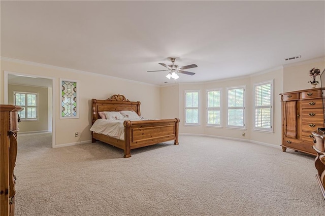 bedroom featuring visible vents, baseboards, crown molding, and light colored carpet