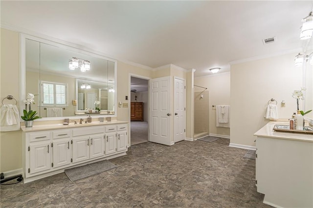 bathroom with visible vents, a stall shower, vanity, baseboards, and ornamental molding