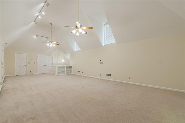 bonus room featuring a ceiling fan, baseboards, a skylight, and light carpet