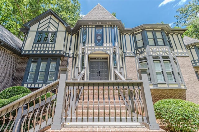 tudor home with brick siding and stucco siding