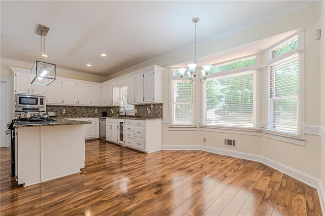 kitchen with wine cooler, stainless steel appliances, dark wood-style floors, and white cabinetry