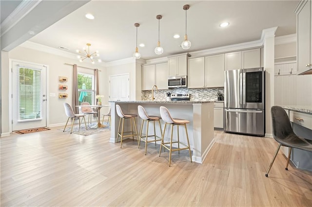 5322 Burrus Ln SW, Mableton, GA 30126 - kitchen with appliances with stainless steel finishes, recessed lighting, light wood-style flooring, tasteful backsplash, and a kitchen breakfast bar