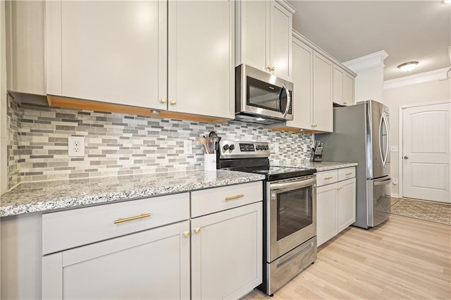 5322 Burrus Ln SW, Mableton, GA 30126 - kitchen featuring appliances with stainless steel finishes, crown molding, backsplash, light wood finished floors, and light stone countertops