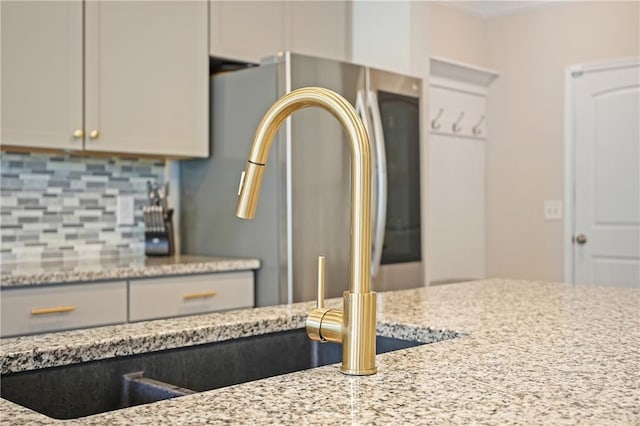 5322 Burrus Ln SW, Mableton, GA 30126 - kitchen featuring tasteful backsplash and light stone counters