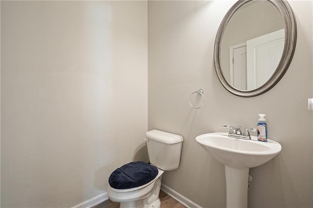 5322 Burrus Ln SW, Mableton, GA 30126 - bathroom with baseboards, toilet, and wood finished floors