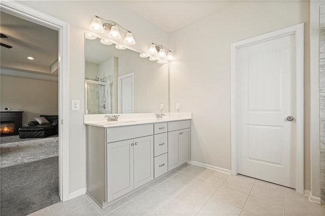 5322 Burrus Ln SW, Mableton, GA 30126 - full bathroom featuring a shower stall, tile patterned floors, baseboards, double vanity, and a glass covered fireplace