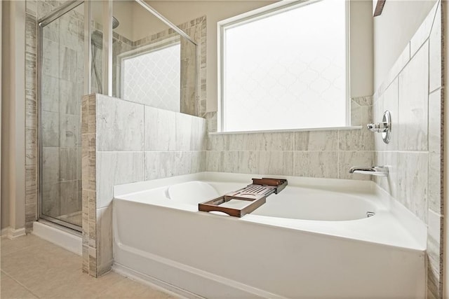 5322 Burrus Ln SW, Mableton, GA 30126 - bathroom featuring a stall shower, a bath, and tile patterned floors