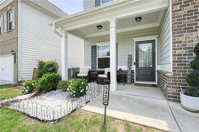 5322 Burrus Ln SW, Mableton, GA 30126 - view of exterior entry featuring a porch, a garage, and brick siding