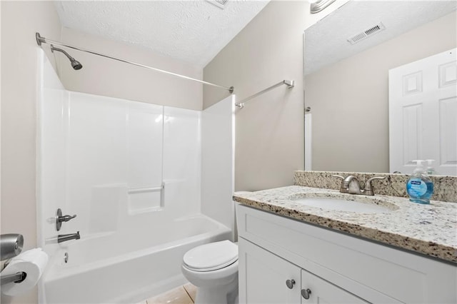 full bathroom featuring a textured ceiling, bathtub / shower combination, toilet, vanity, and tile patterned floors