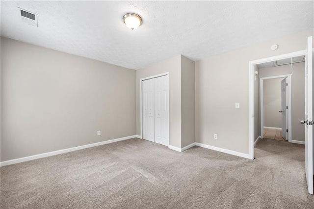 unfurnished bedroom featuring a closet and carpet flooring