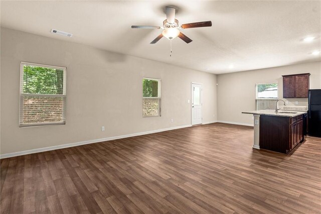 10786 Wheeler Trce, Hampton, GA 30228 - unfurnished living room with a ceiling fan, a sink, dark wood-style flooring, baseboards, and recessed lighting