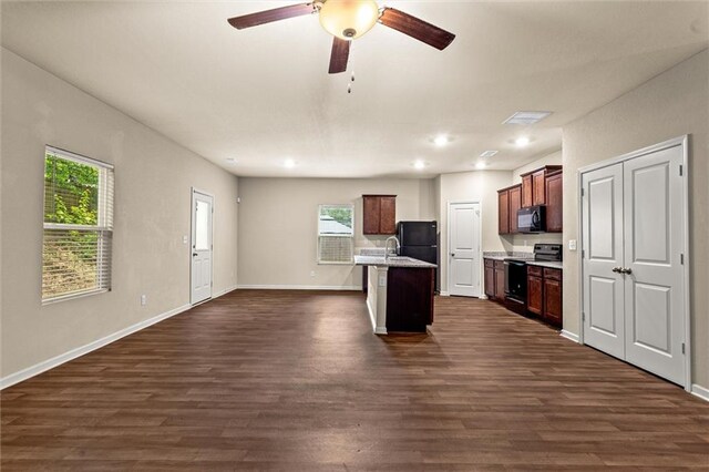 10786 Wheeler Trce, Hampton, GA 30228 - kitchen with black appliances, open floor plan, dark wood-style floors, plenty of natural light, and recessed lighting