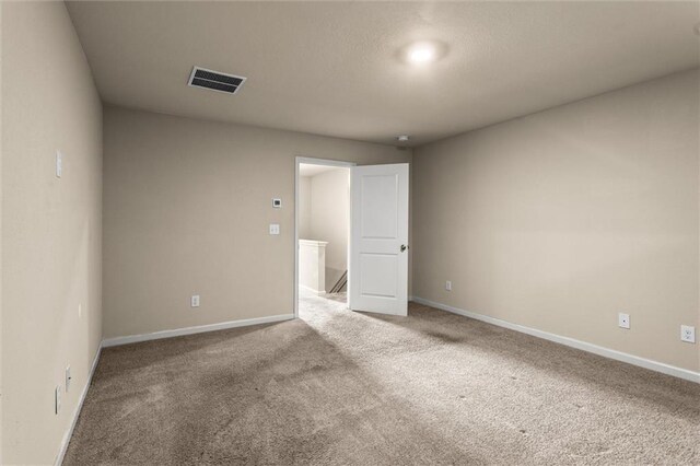 10786 Wheeler Trce, Hampton, GA 30228 - spare room featuring light colored carpet and baseboards