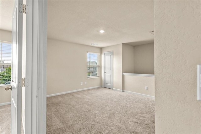 10786 Wheeler Trce, Hampton, GA 30228 - spare room featuring carpet flooring, baseboards, and a textured ceiling