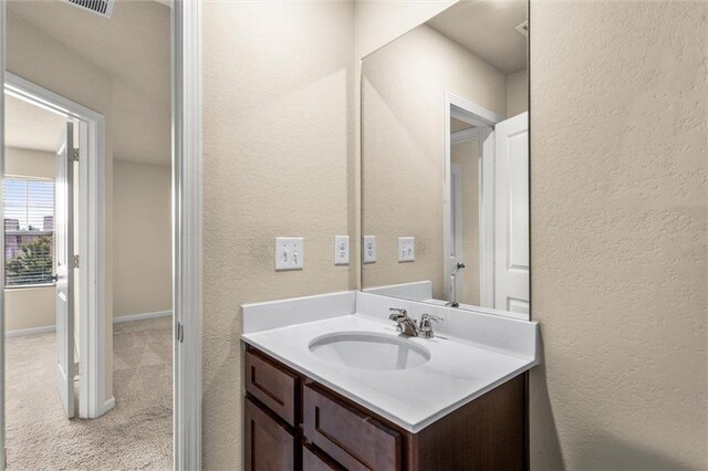 10786 Wheeler Trce, Hampton, GA 30228 - bathroom with vanity and a textured wall