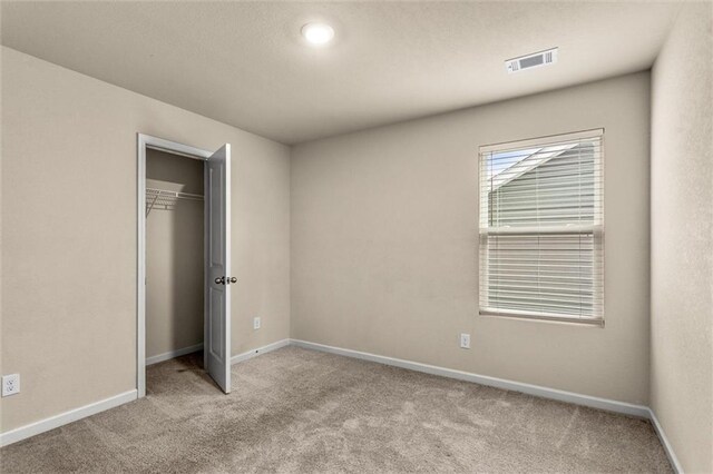 10786 Wheeler Trce, Hampton, GA 30228 - unfurnished bedroom with carpet floors, baseboards, and a closet