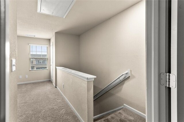 10786 Wheeler Trce, Hampton, GA 30228 - hall featuring attic access, an upstairs landing, and carpet flooring