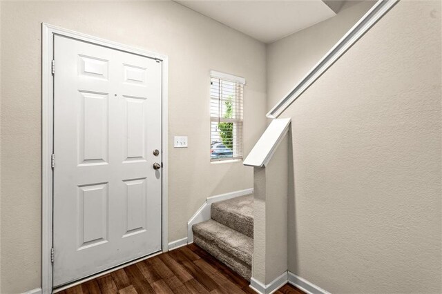 10786 Wheeler Trce, Hampton, GA 30228 - foyer featuring dark wood finished floors, stairs, and baseboards