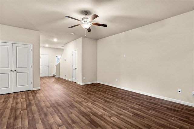 10786 Wheeler Trce, Hampton, GA 30228 - unfurnished living room featuring a ceiling fan, baseboards, and dark wood-style floors