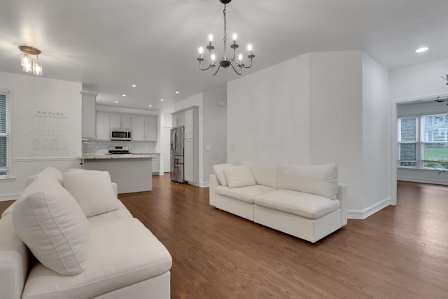 11280 Brookhollow Trl, Alpharetta, GA 30022 - living area with dark wood-style floors, baseboards, a chandelier, and recessed lighting